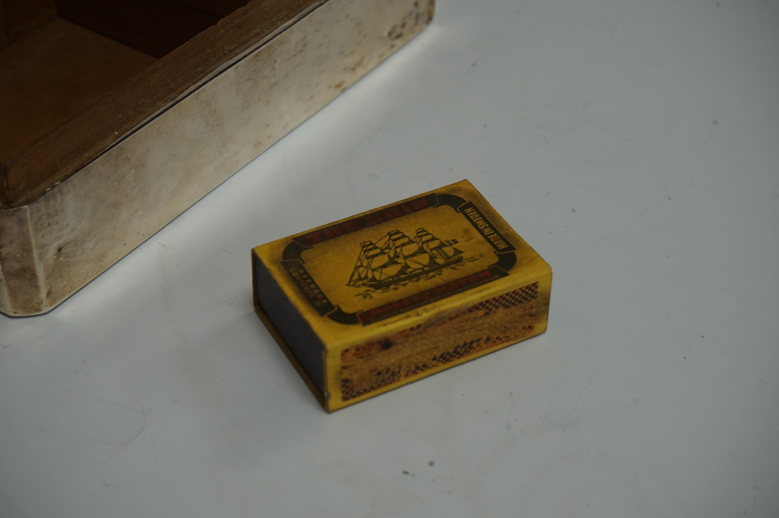 A George V silver mounted rectangular cigarette box, by Harrods Ltd, Birmingham, 1935, 16.6cm. Condition - poor to fair